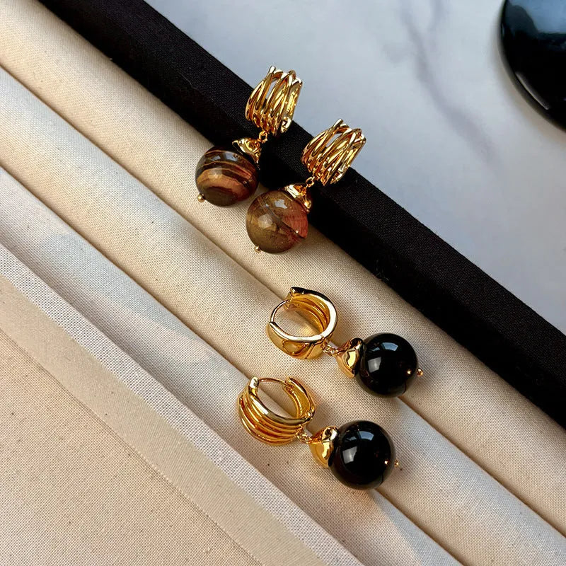 Tigereye geometric earrings with gold plating in brown or black colours featuring circular French retro design