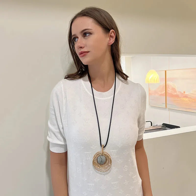 Gold tone geometric pendant necklace with snake chain for women, adjustable up to 80cm.