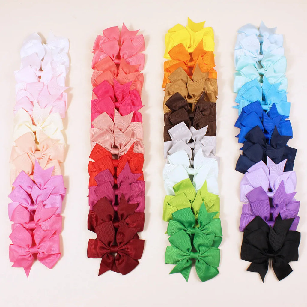 Assortment of 20 colourful handmade grosgrain ribbon hair bows with alligator clips for toddlers.