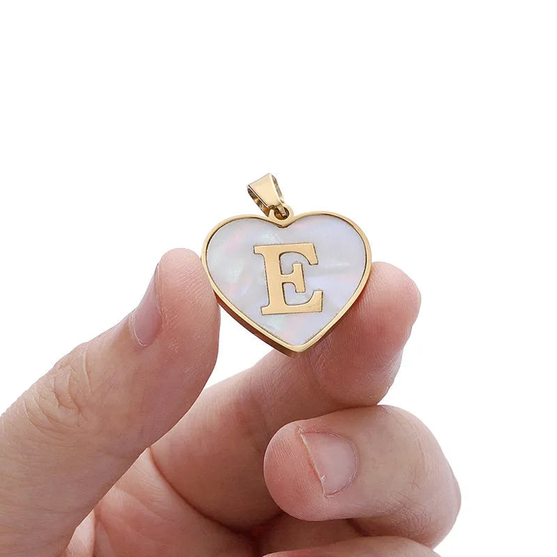 Gold plated heart-shaped necklace with white shell pendant on adjustable stainless steel chain