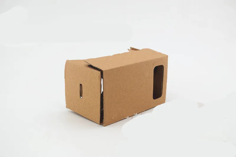 Pink and white folding cardboard VR glasses viewer for smartphones with 3D lenses and head strap.