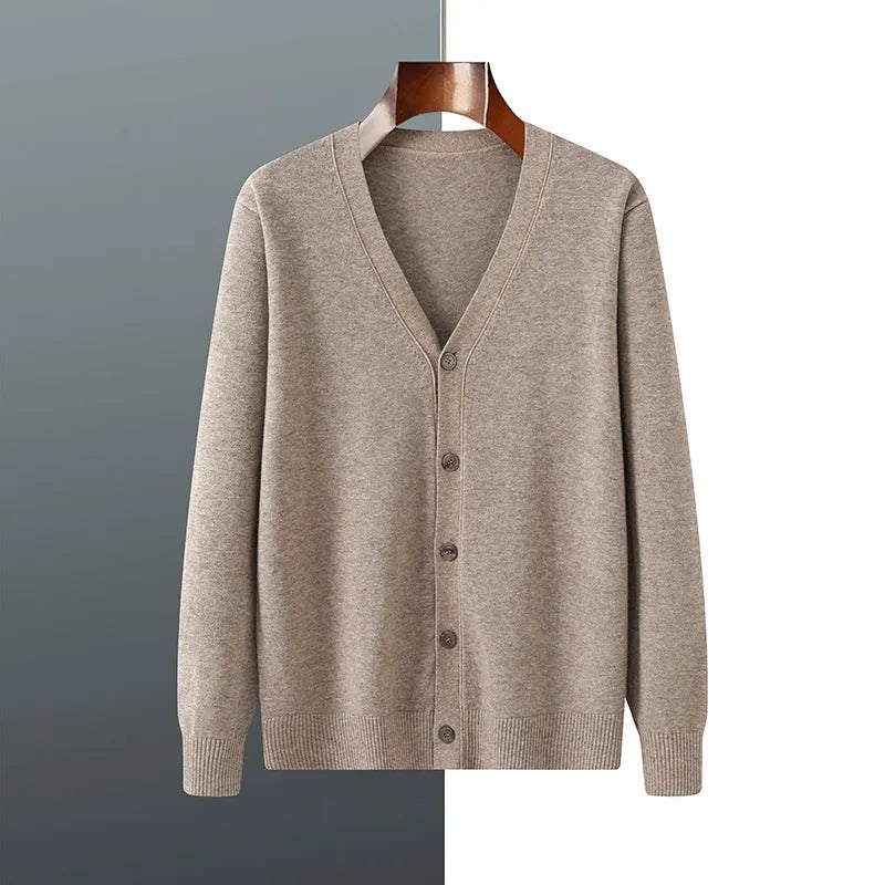 Man wearing a beige V-neck Andy velvet cardigan coat with a loose fit and long sleeves.