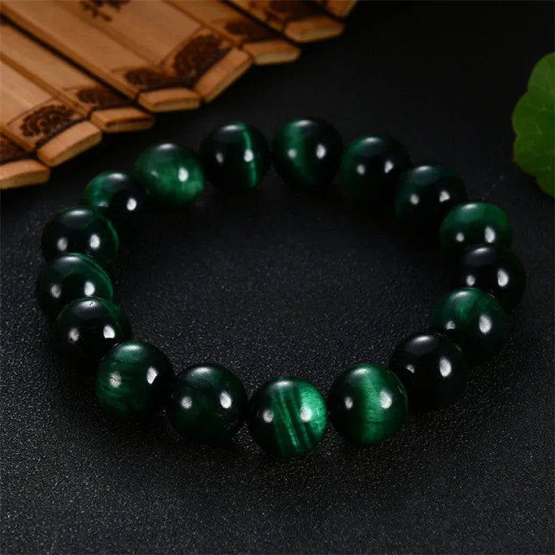 Green tiger eye stone bracelet with geometric beads on a wrist