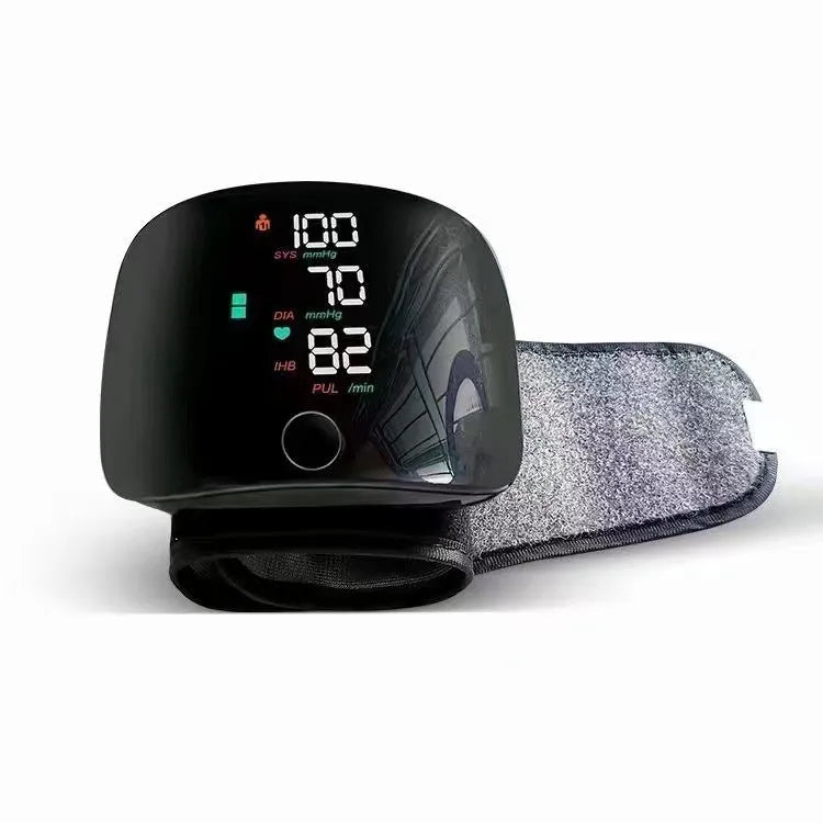 Black wrist sphygmomanometer with digital display and voice prompt buttons for home blood pressure monitoring