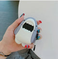 Silicone protective cover for Apple AirPods 1 and 2 charging case with clip-on shark fin decoration.