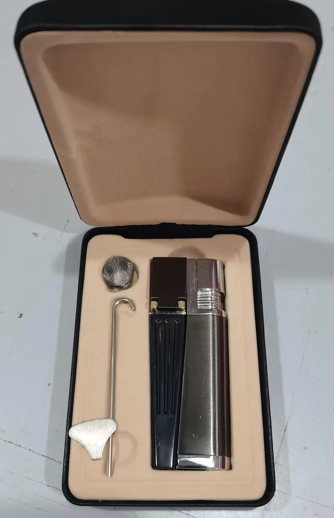 Folding metal pipe lighter showing open position with stash compartment visible