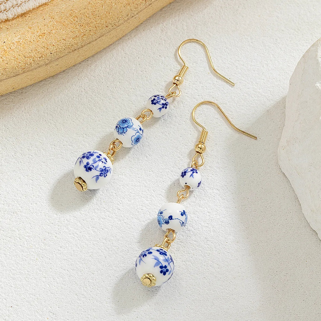 Long blue and white porcelain ceramic bead earrings with alloy frame in a retro Chinese style.