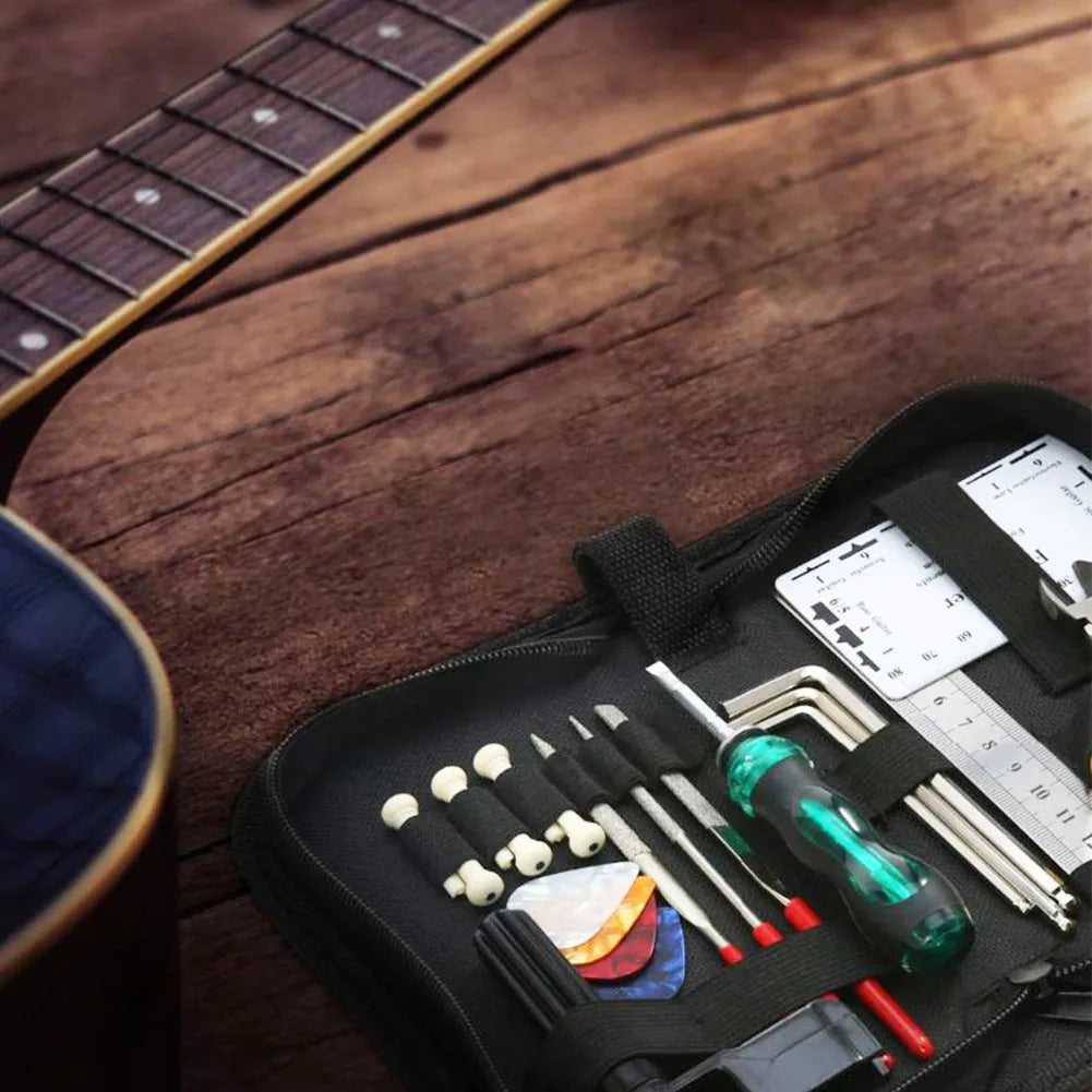 Black plastic and metal guitar repair tool kit with case for instrument maintenance