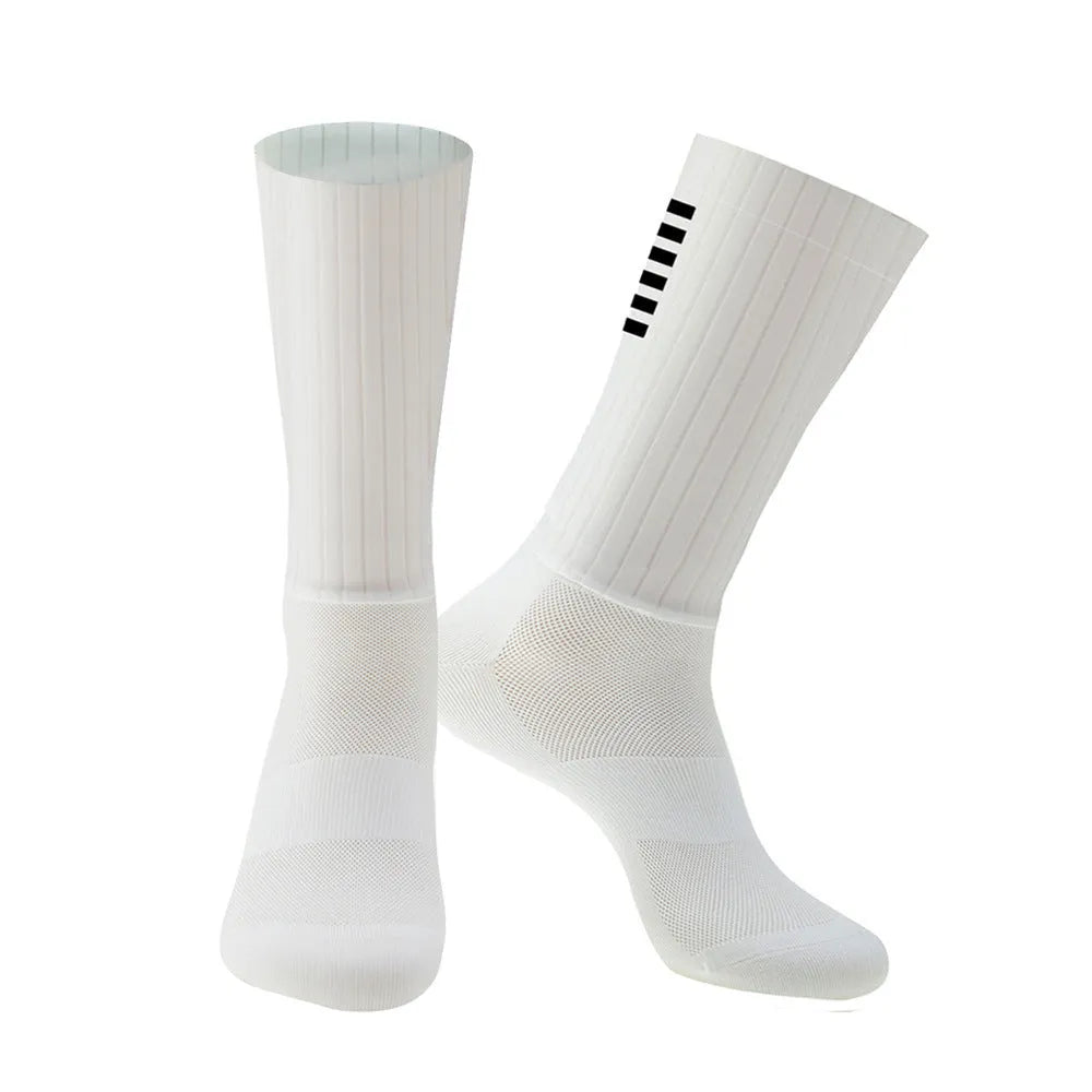 Pair of breathable athletic socks for running and cycling in orange colour on a grey background