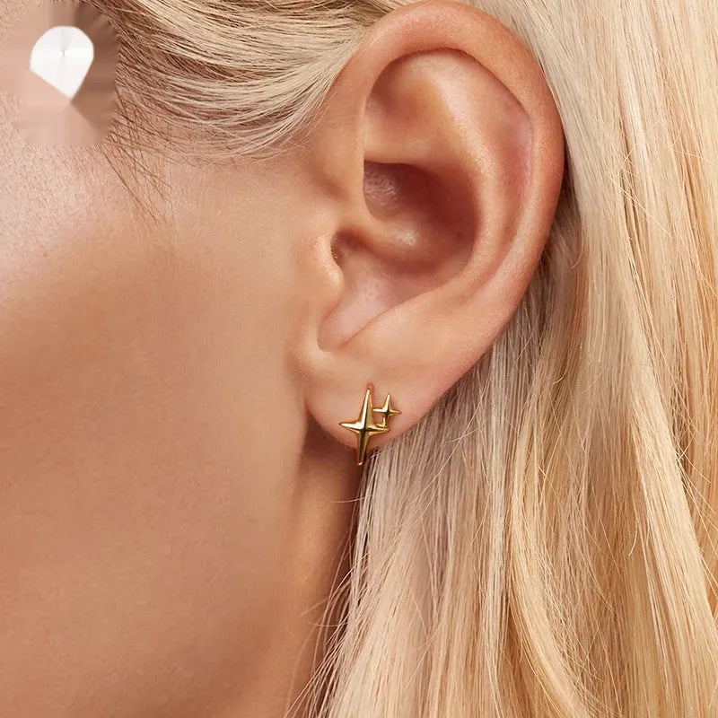 Minimalist star sterling silver ear clips with oxidised finish and XINGX element styling