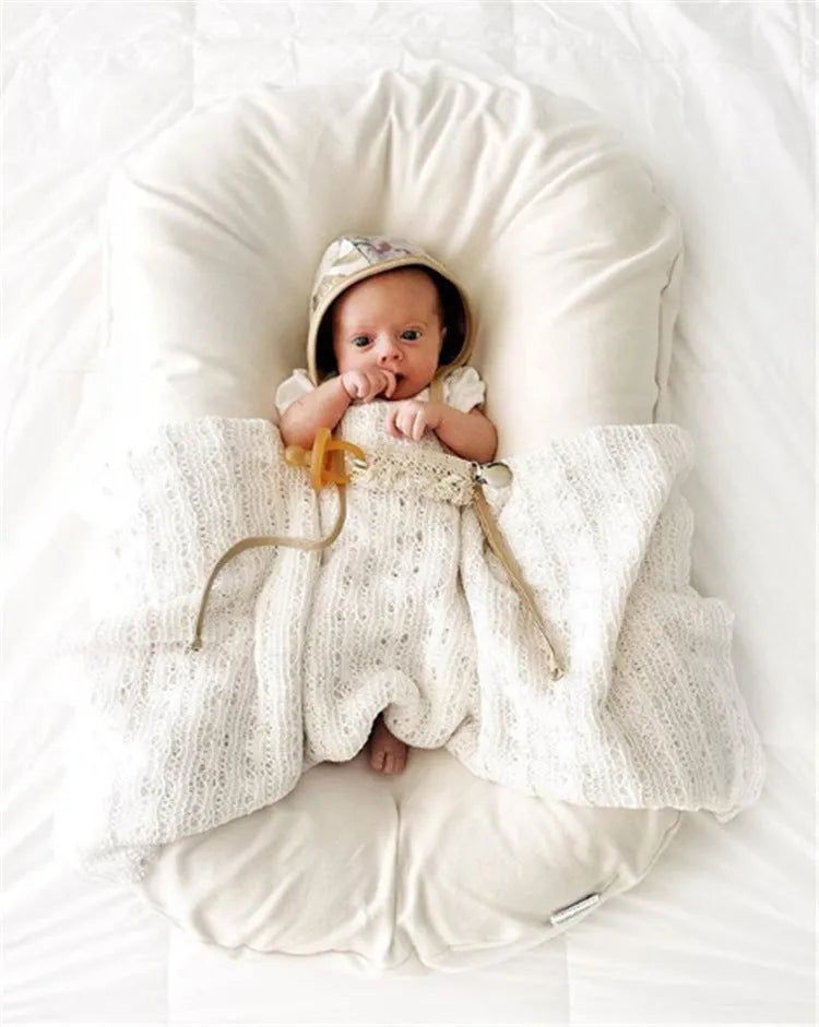 Beige portable cotton baby nest crib for newborn, measuring 75cm by 45cm.