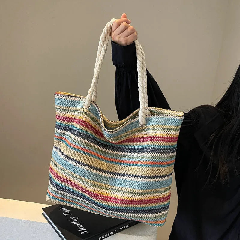 Blue straw woven shoulder bag with single strap showing textured exterior