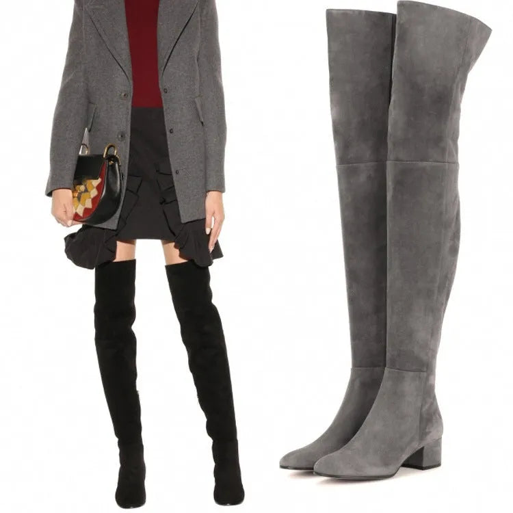 Women's grey suede over the knee flat boots with a pointed toe and low thick rubber sole.