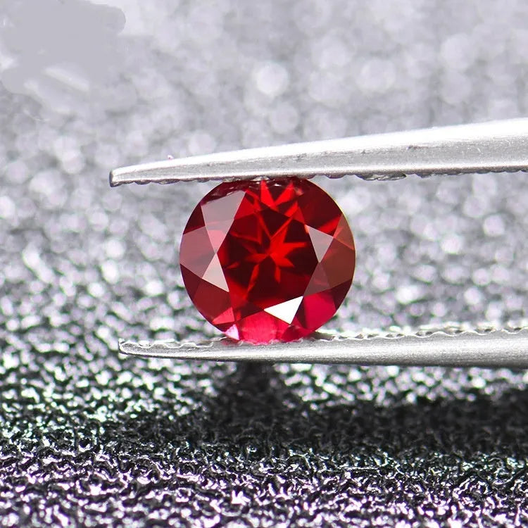 Laboratory-created pigeon blood red ruby gemstone showing different cutting styles including round, princess, and water drop