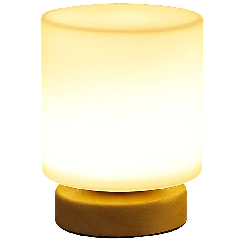 Nordic solid wood USB table lamp in a white geometric shape on a wooden surface.