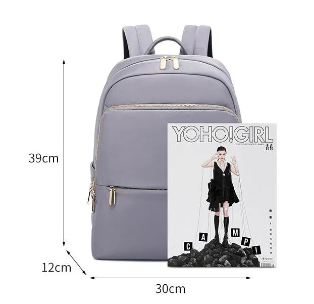 Oxford cloth women's backpack in black and purplish grey, showing large capacity and shoulder straps.