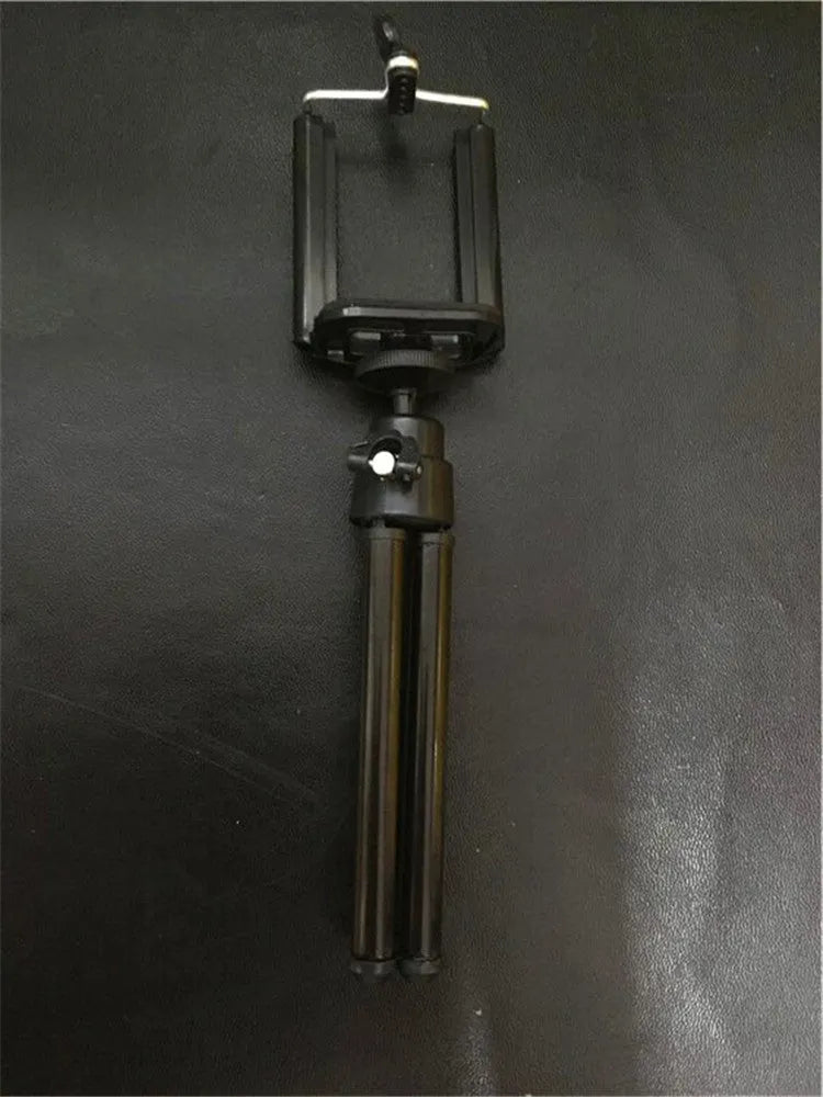 Black aluminium desktop phone holder with adjustable two-section bracket holding a mobile phone