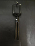 Black aluminium desktop phone holder with adjustable two-section bracket holding a mobile phone