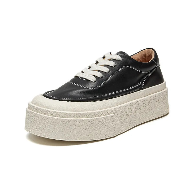 Women's black platform casual board shoes with embossed cowhide upper and round toe design