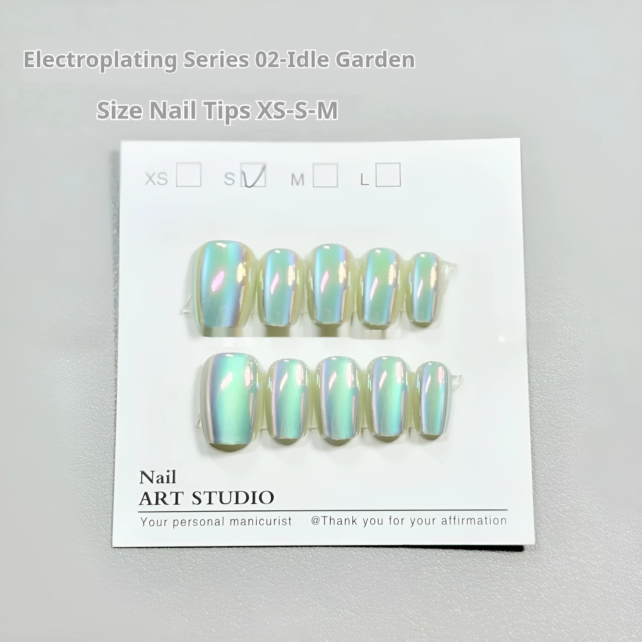 Electroplated Cat's Eye false nail set showing aurora armour and solid colour styles in short ladder sizes.