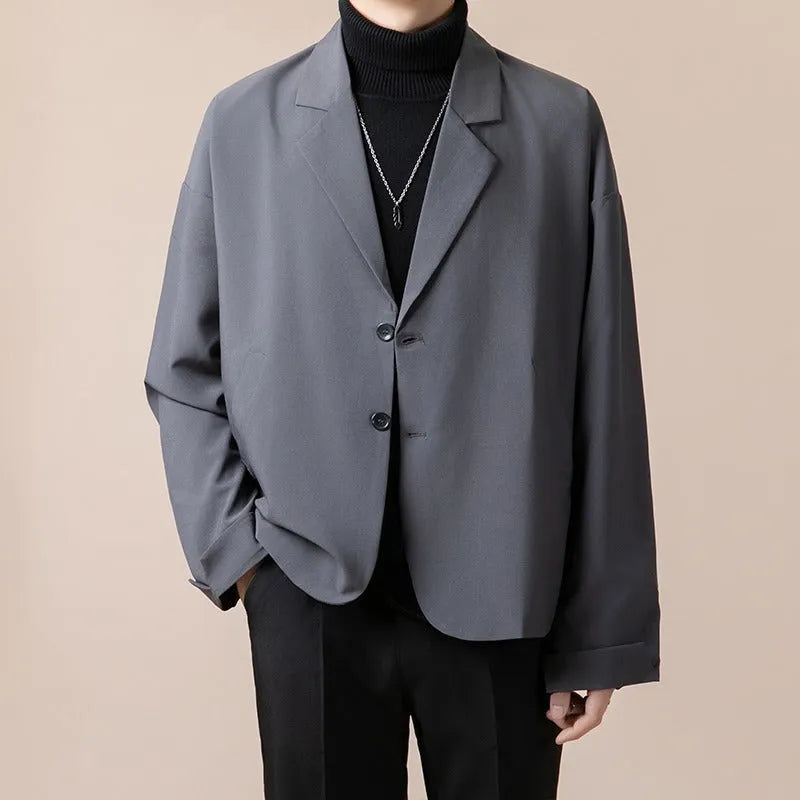 A man's loose-fit casual suit jacket in a polyester blend fabric, shown in one of four available colours.