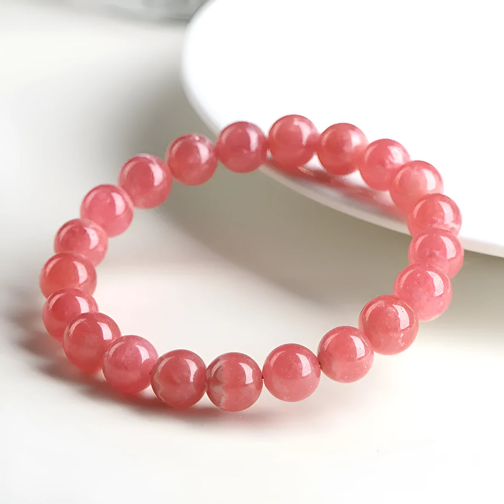 Women's geometric crystal bracelet with a red rhodochrosite stone and silver longevity lock clasp.