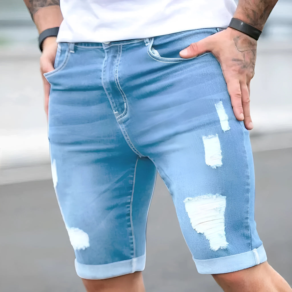 Sky blue men's denim shorts with a multi-hole distressed design and a straight leg.