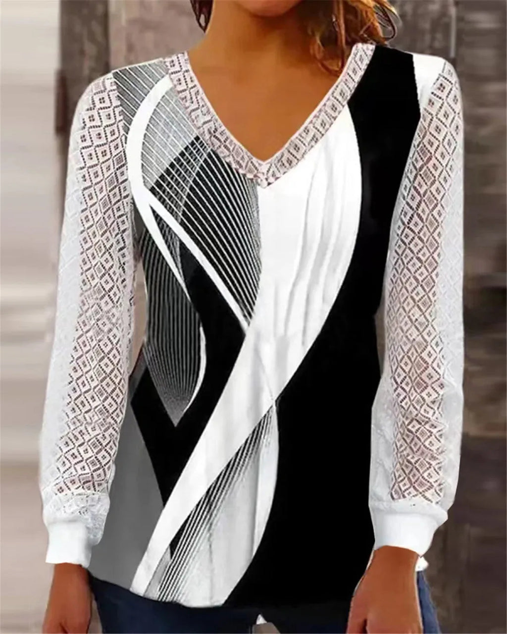 Purple v-neck loose lace top with hollow-out pattern and long sleeves on hanger