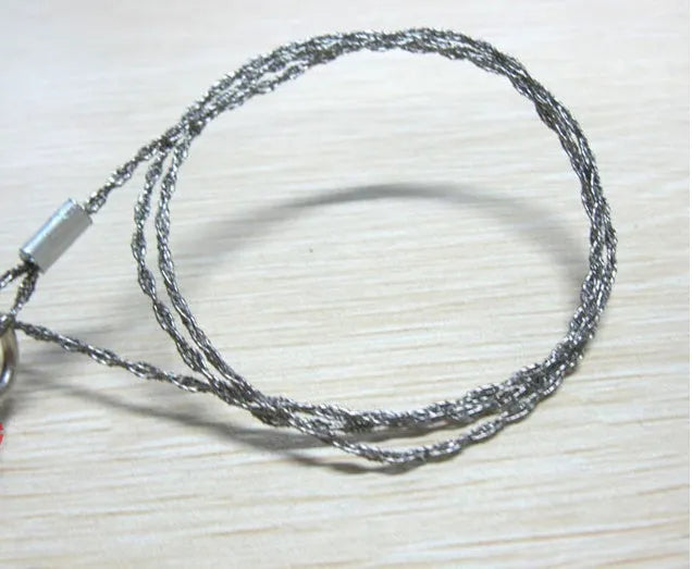 Stainless steel survival wire saw with thumb rings, total length 70cm for outdoor cutting tasks.