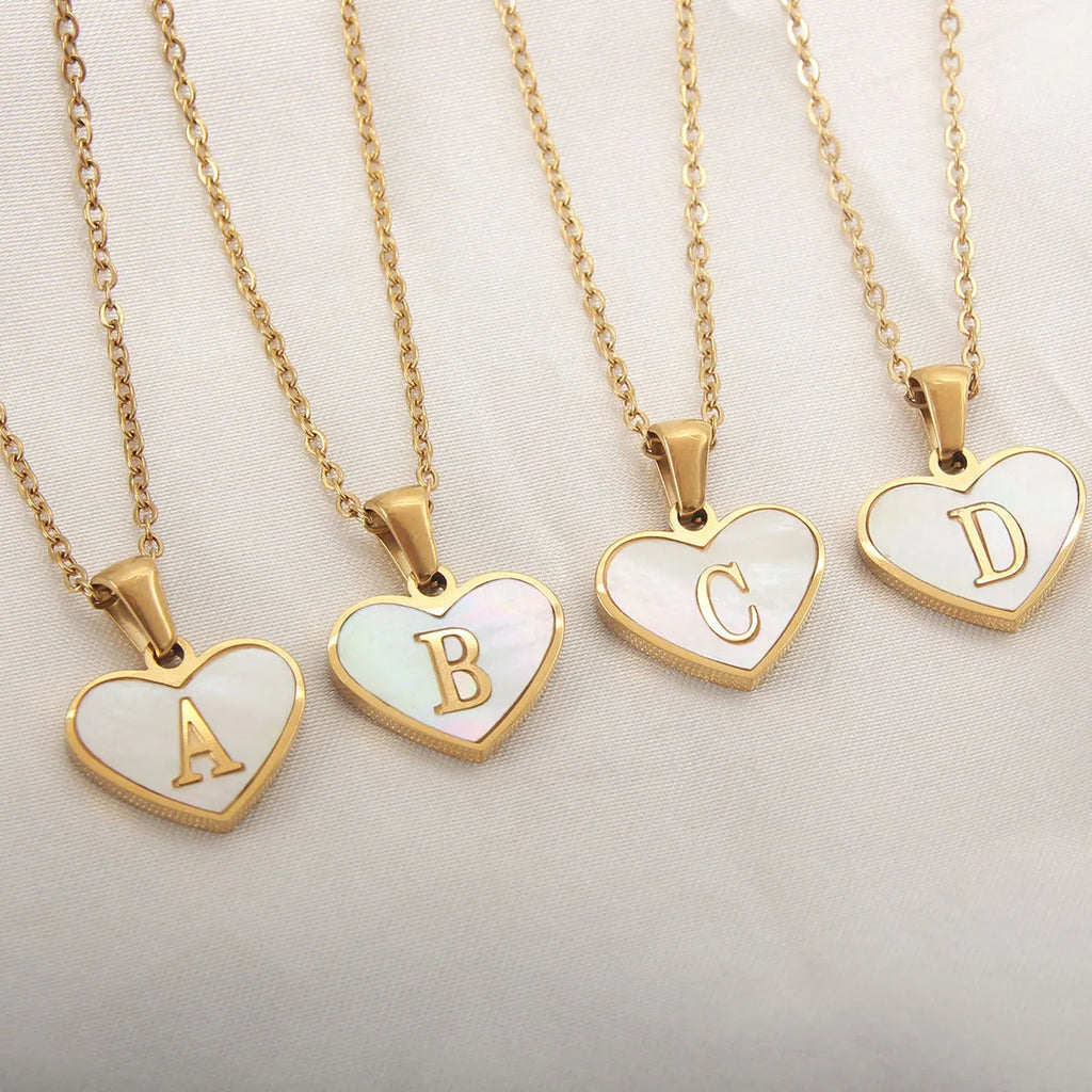 Gold plated heart-shaped necklace with white shell pendant on adjustable stainless steel chain