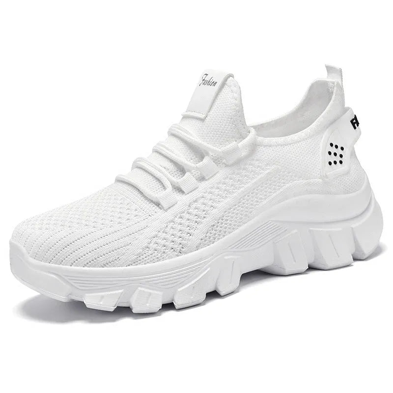 Men's white Flyknit sneakers with a thick PVC sole and round toe on a plain background.