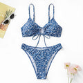 Blue women's three-piece swimsuit set with top and shorts on a white background.