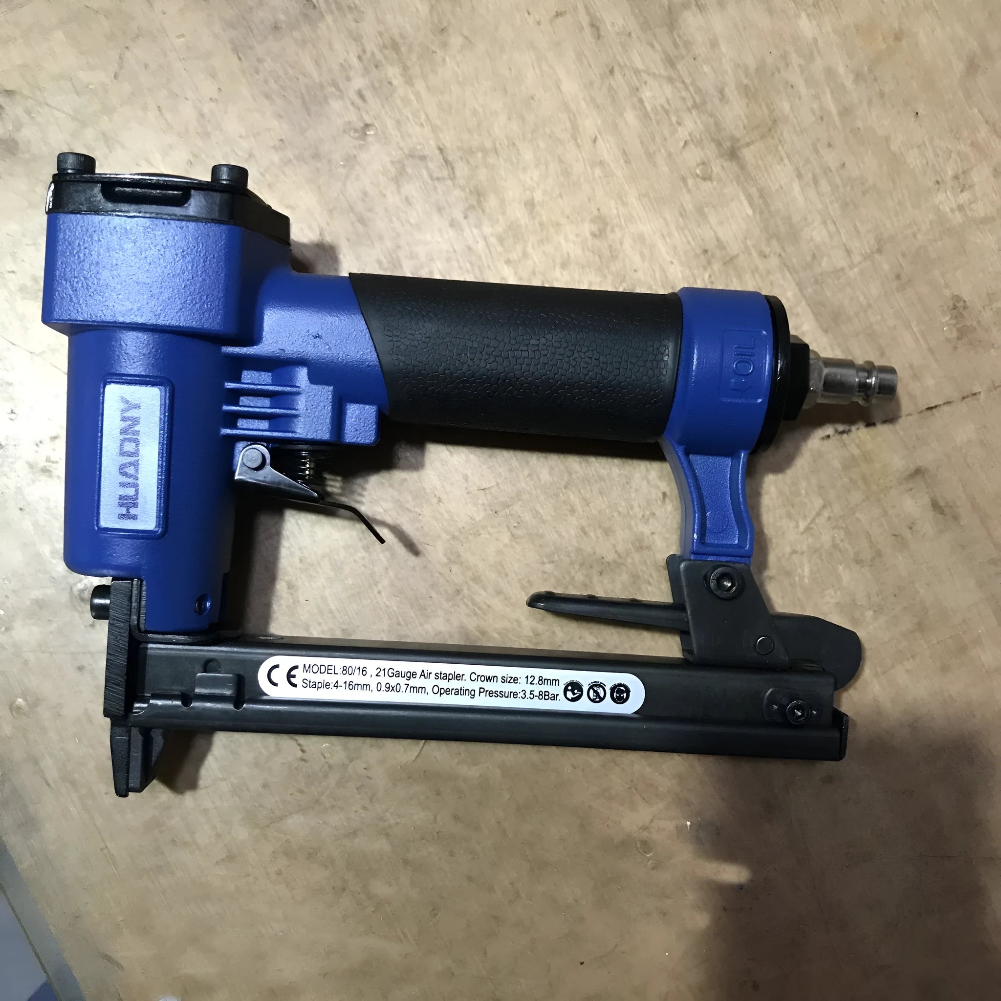 Blue and yellow U-type pneumatic strip nail gun for decoration and upholstery work.