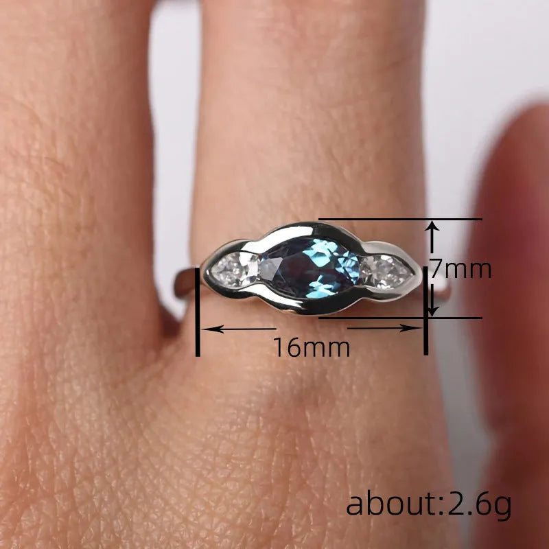 Geometric ellipse women's ring with inlaid zircon stones in white gold colour