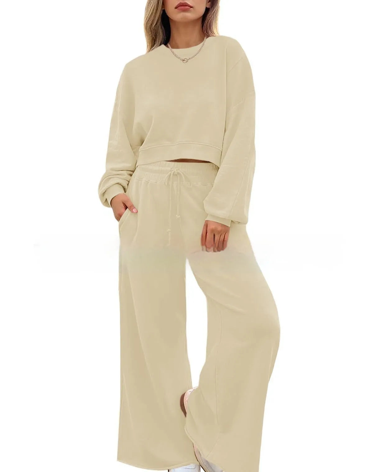 Women's solid colour long sleeve top and trousers two-piece set in polyester fabric.