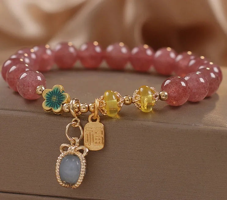 Red strawberry quartz and rhinestone beaded bracelet with an alloy clasp.