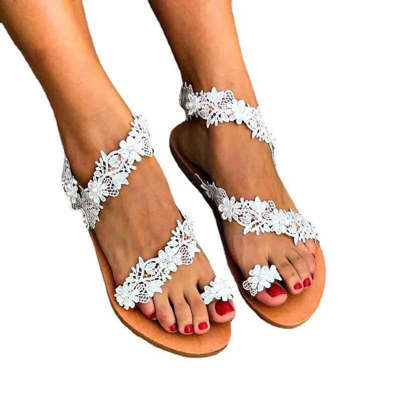 White plus size women's flat shoes with rhinestone and flower decoration on the upper.