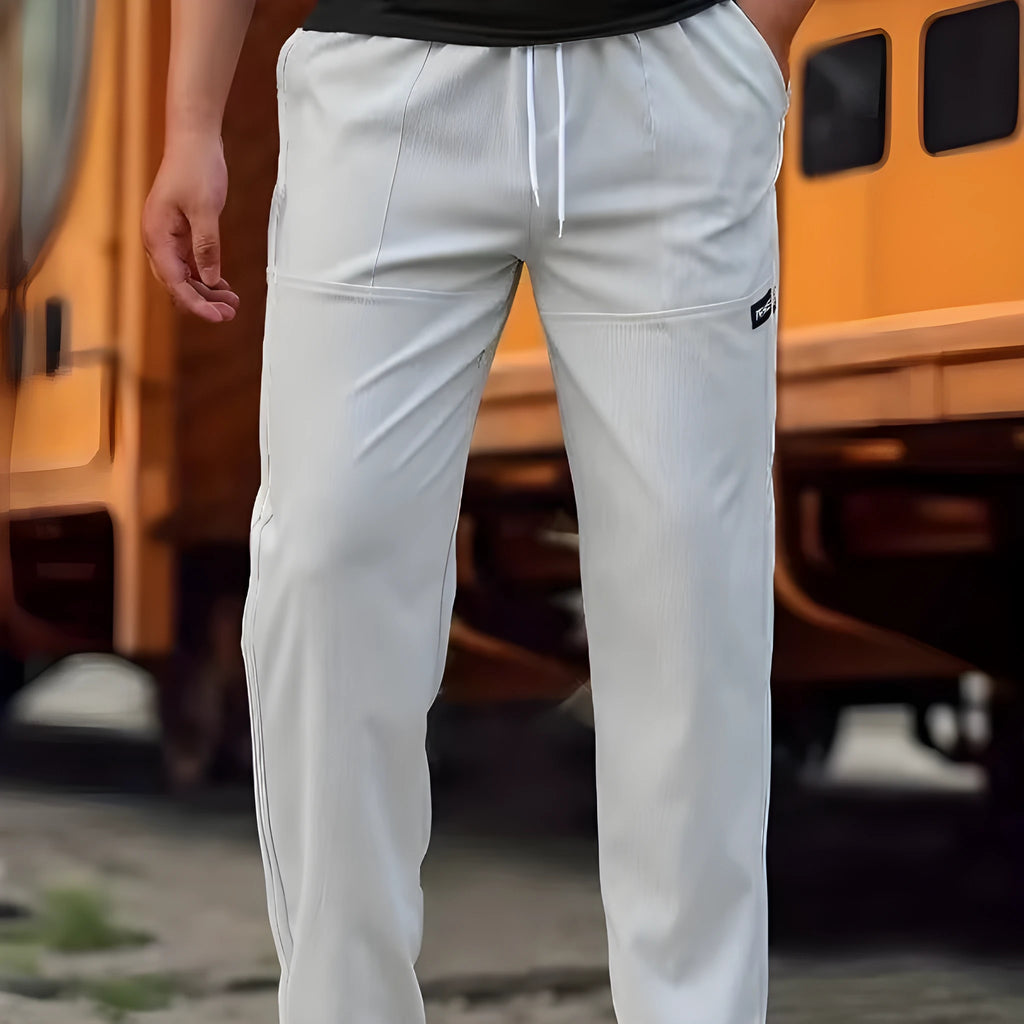 Men's straight-leg lightweight polyester trousers in light grey colour, laid flat showing front design