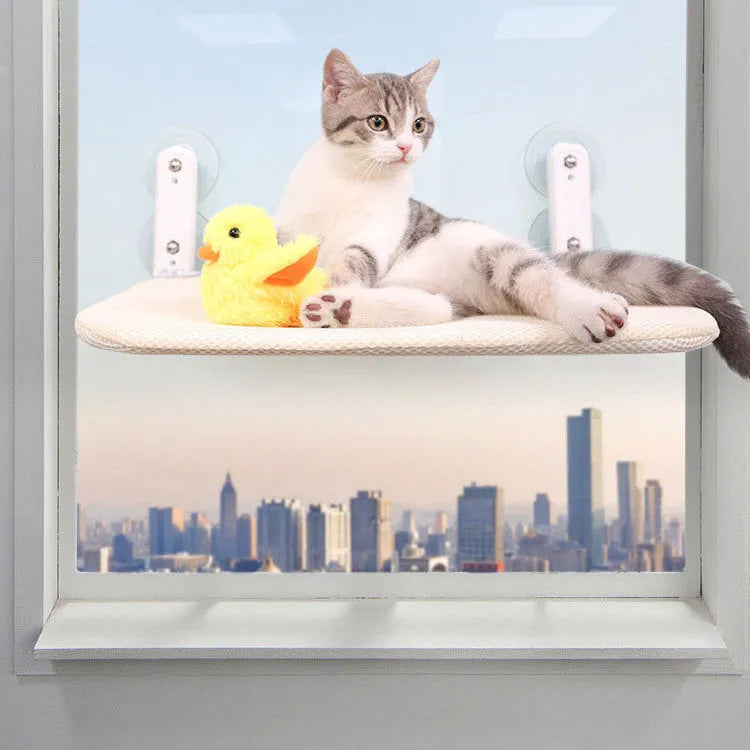 Universal grey mesh cat hammock with suction cups mounted on a window