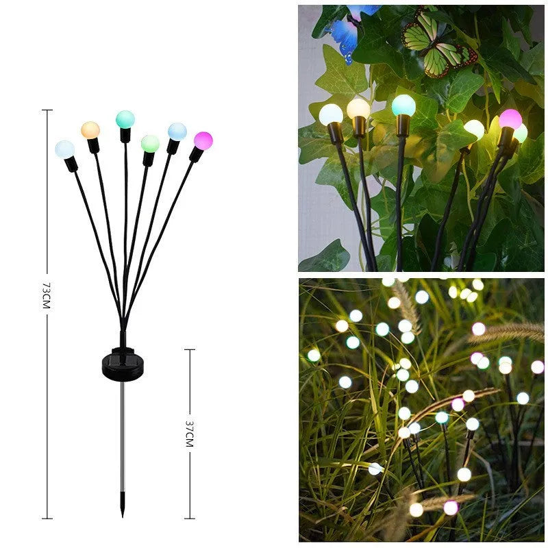 Solar-powered LED garden ground light with stainless steel spike inserted in lawn showing automatic dusk-to-dawn operation