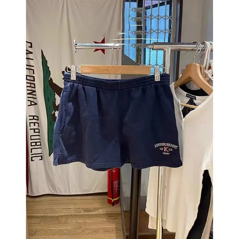 Women's dark blue cotton sports shorts with white flag embroidery and navy blue trim