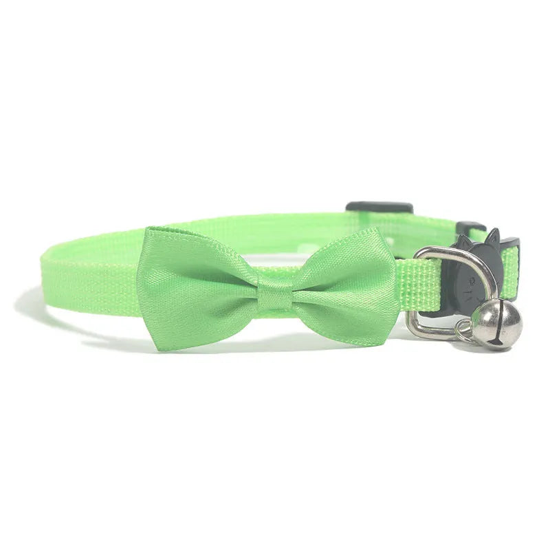 Adjustable nylon cat collar with decorative bow and bell in multiple colour options including red, blue, pink and green