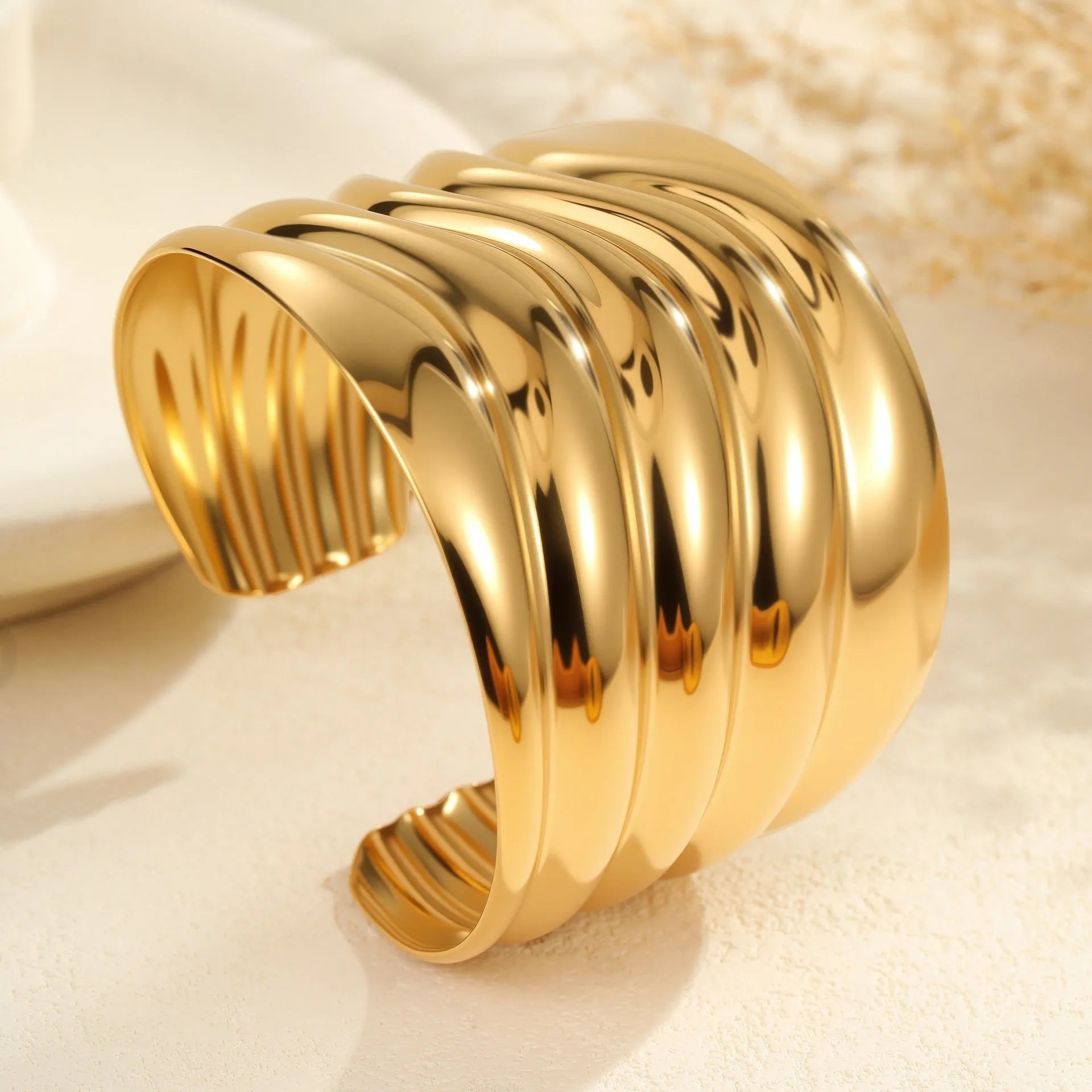 Women's exaggerated wide stainless steel bracelet with 18K gold plating and geometric wave design