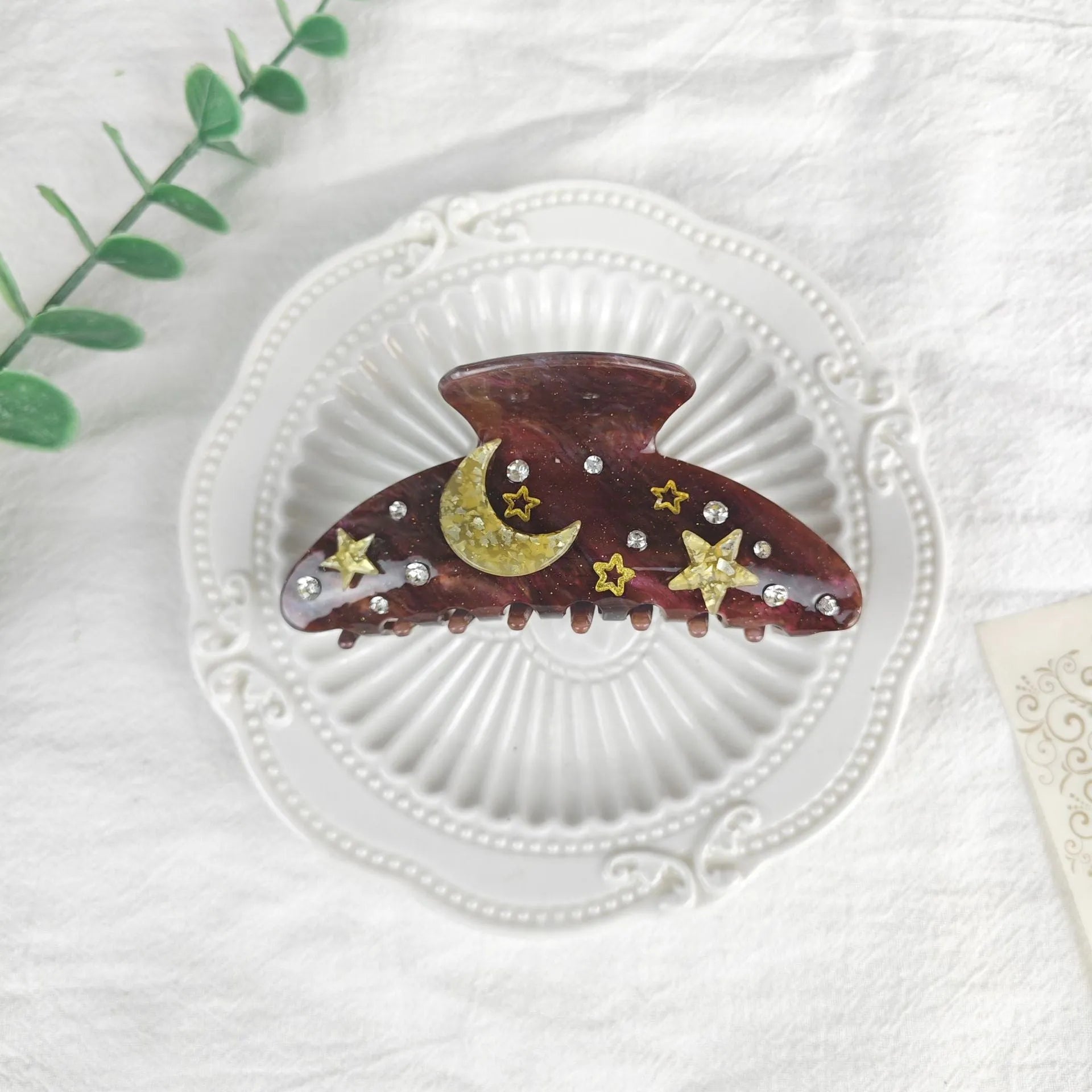 Oversized women's barrette with a starry sky design in blue, made from cellulose acetate sheet.