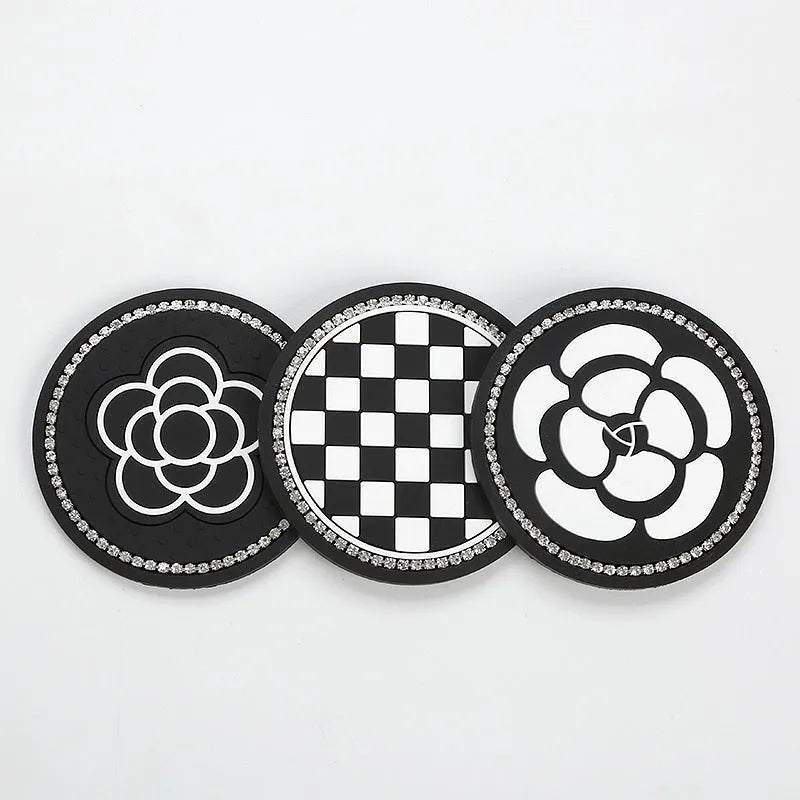 Black and white checkerboard pattern PVC car cup holder mat inserted in a vehicle centre console.