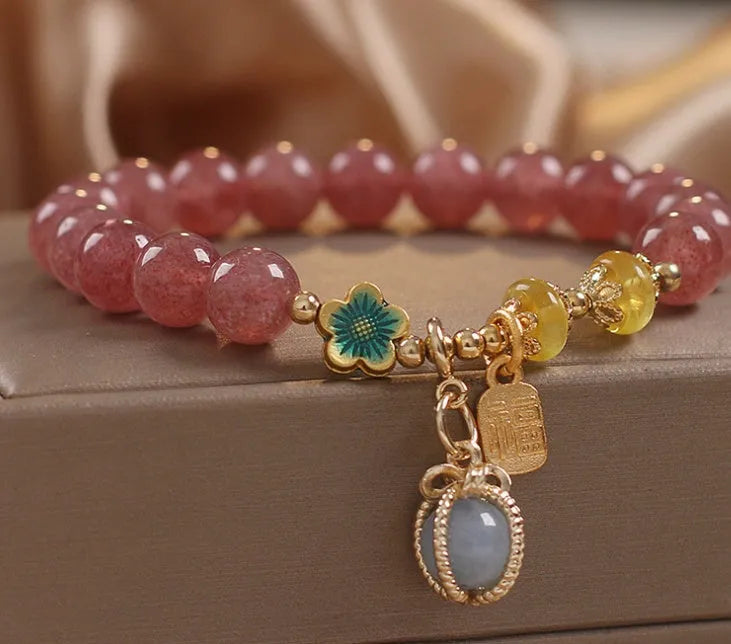 Red strawberry quartz and rhinestone beaded bracelet with an alloy clasp.