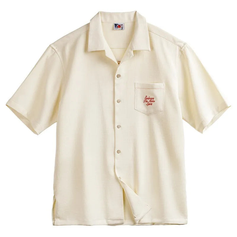 Light apricot men's shirt with bamboo plant pattern and Cuban collar on hanger