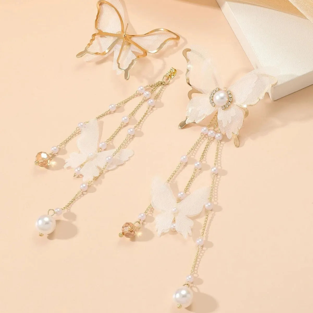 White butterfly earrings with lace patterns, rhinestones, pearls and tassel drops