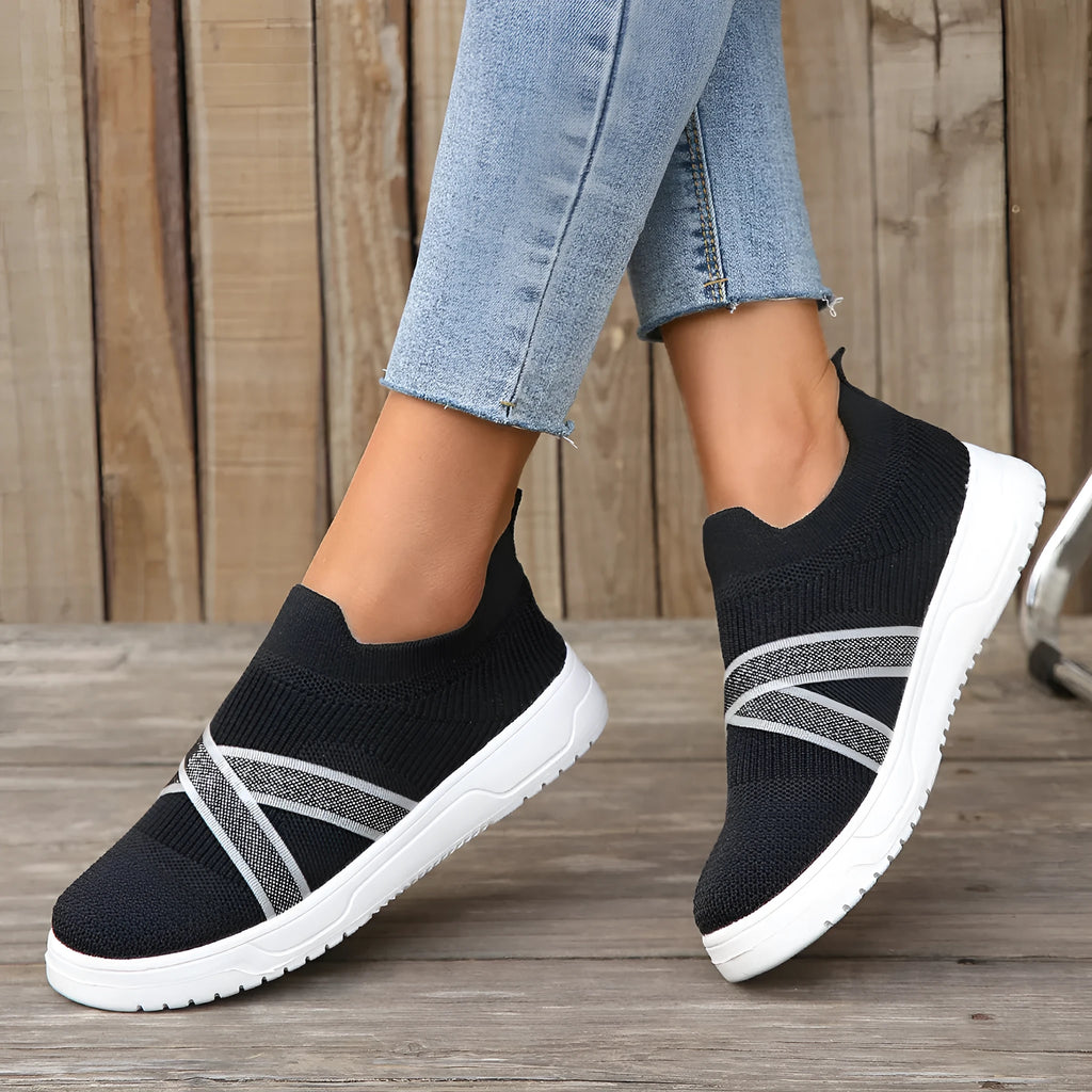 Black women's flat knit mesh shoes with tassel detail and rubber sole