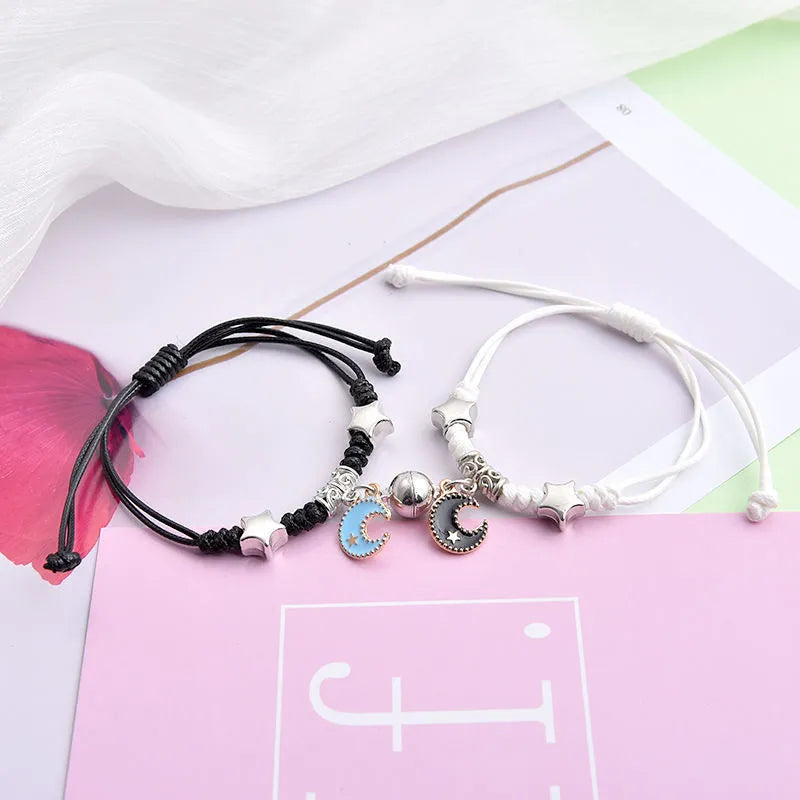Alloy couple bracelets with magnet closure showing various design options including crown, clover, and text patterns